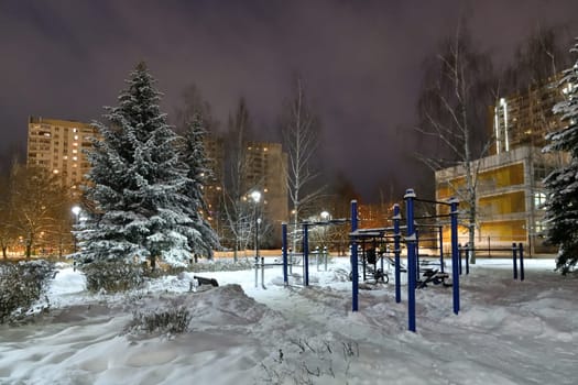 Winter cityscape with multi-storey residential buildings and snow covered fir trees in Moscow, Russia