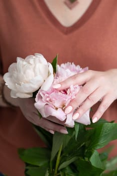 girl's hands with a beautiful pink manicure design, pastel color, gently, flowers in spring. High quality photo