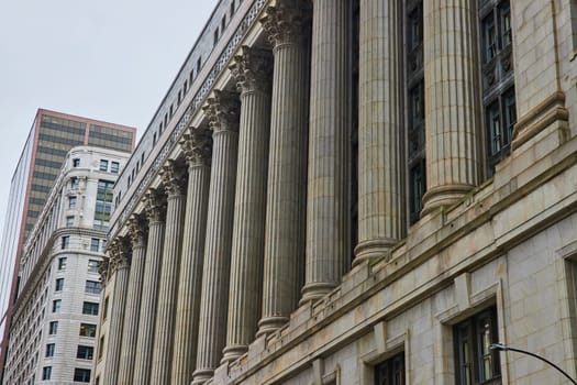 Image of Grey building with pillars and columns on overcast day with gloomy, ominous sky, Chicago, IL