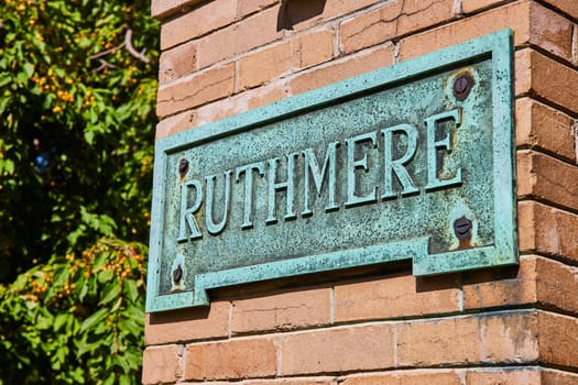 Antique Ruthmere Plaque on Brick Wall in Lush Environment, Elkhart, Indiana, 2023