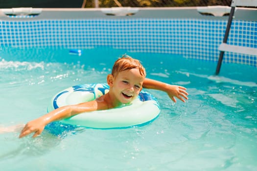 Cute boy relaxing on inflatable toy ring floating in pool have fun during summer vacation. Child having fun in swimming pool