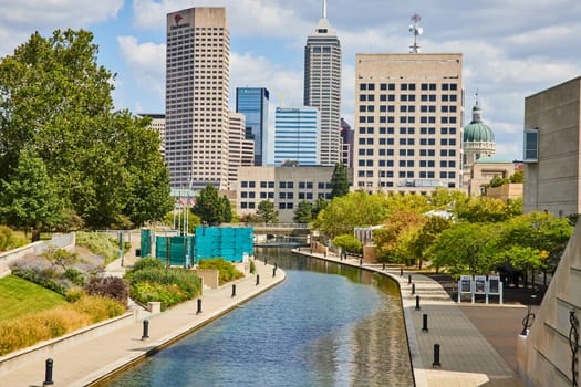 Vibrant Indianapolis Skyline with Reflective Canal and Modern Architecture, Embracing Urban Progress and Tranquility, 2023