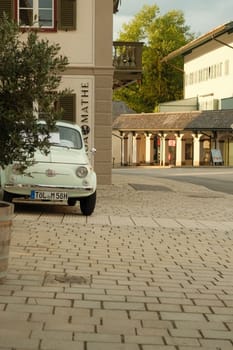 Vertical shot of Pastel Fiat 500 classic car in Gmund am Tegernsee, Bavaria, Germany