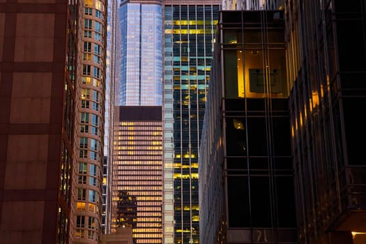 Image of Colorful, gorgeous windows with lights at sunset, skyscrapers in Chicago, IL night life, pretty