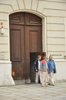 Craftsmen step out of the huge Marschalltor in Vienna, Austria