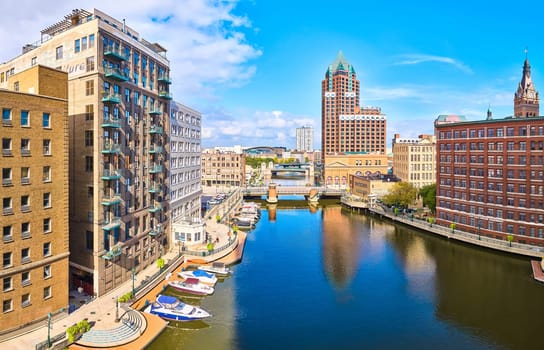 Aerial panoramic view of Milwaukee's vibrant urban landscape with classic and modern architecture along the canal, captured by DJI Mavic 3 drone in 2023.