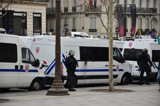 Police Officers wearing helmets and carrying batons during yellow vests protests in Paris, France