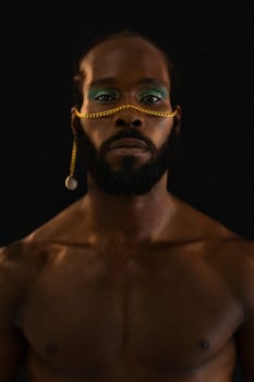 Confident african-american bearded gay man with bright makeup isolated on black background, Close up portrait. Gay African man wearing make-up looking at camera.