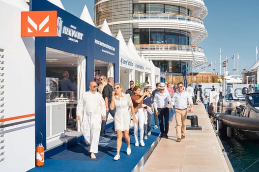 Monaco, Monte Carlo, 28 September 2022 - a lot of people, clients and yacht brokers look at the mega yachts presented, discuss the novelties of the boating industry at the famous motorboat exhibition. High quality photo