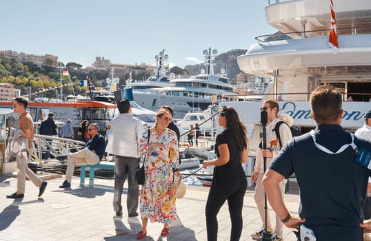 Monaco, Monte Carlo, 28 September 2022 - a lot of people, clients and yacht brokers look at the mega yachts presented, discuss the novelties of the boating industry at the famous motorboat exhibition. High quality photo