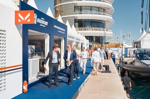 Monaco, Monte Carlo, 28 September 2022 - a lot of people, clients and yacht brokers look at the mega yachts presented, discuss the novelties of the boating industry at the famous motorboat exhibition. High quality photo