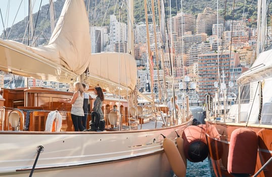 Monaco, Monte Carlo, 28 September 2022 - Invited wealthy clients inspect megayachts at the largest fair exhibition in the world yacht show MYS, port Hercules, yacht brokers, sunny weather. High quality photo