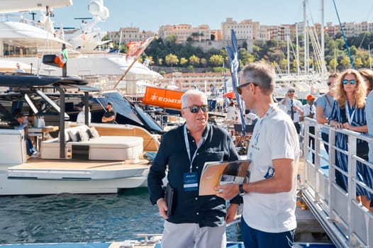 Monaco, Monte Carlo, 28 September 2022 - a lot of people, clients and yacht brokers look at the mega yachts presented, discuss the novelties of the boating industry at the famous motorboat exhibition. High quality photo