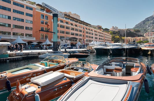 Monaco, Monte Carlo, 28 September 2022 - Riva boats in a row and a lot of luxury mega yachts at the famous motorboat exhibition in the principality, yacht brokers and clients. High quality photo