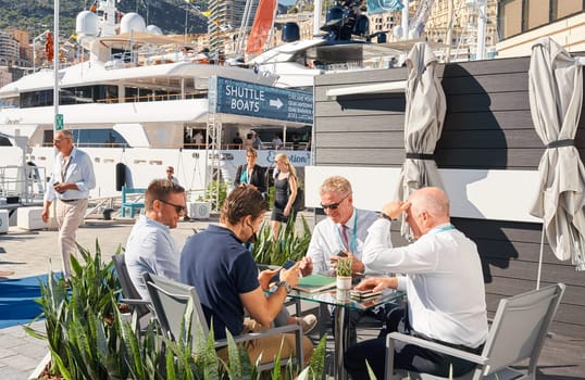 Monaco, Monte Carlo, 28 September 2022 - a lot of people, clients and yacht brokers look at the mega yachts presented, discuss the novelties of the boating industry at the famous motorboat exhibition. High quality photo