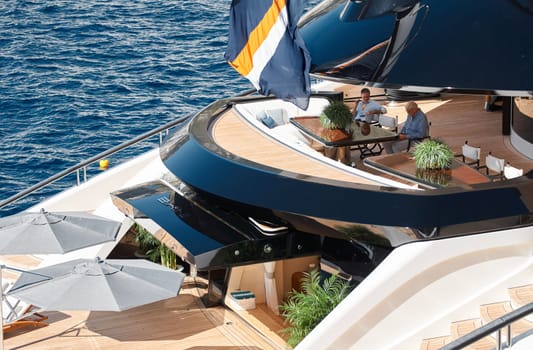 Monaco, Monte Carlo, 28 September 2022 - The richest wealth people are sitting on the deck of a mega yacht and enjoying life, the largest fair exhibition in the world yacht show MYS, yacht brokers. High quality photo