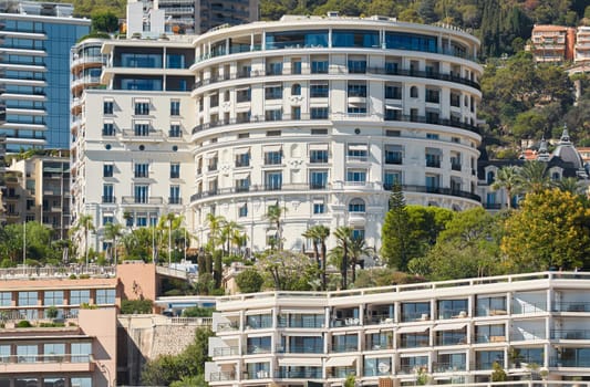Monaco, Monte-Carlo, 28 September 2022 - Famous landmark hotel de Paris at sunset, mountain on background, wealth life. High quality photo
