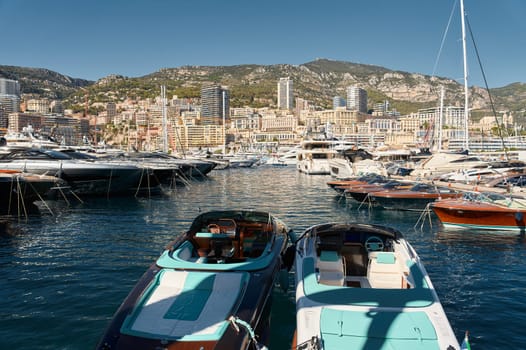 Monaco, Monte Carlo, 28 September 2022 - Riva boats in a row and a lot of luxury mega yachts at the famous motorboat exhibition in the principality, yacht brokers and clients. High quality photo