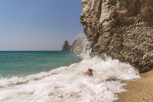 Women ocean play. Seaside, beach daytime, enjoying beach fun. Two women in red swimsuits enjoying themselves in the ocean waves