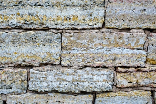Textured Bricks, stone Background. The worn facade of the building