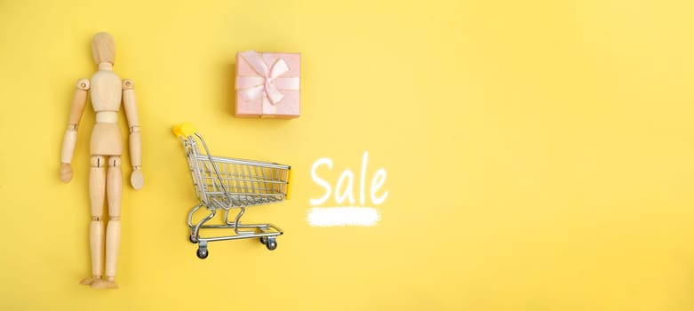 Small Shopping Cart and a Gift Box. Sale, shopping. Banner, copy space
