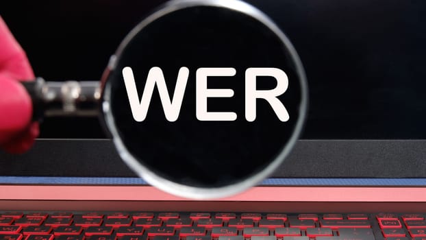 Who, German word for Who, (German: Wer) text on the monitor found through a magnifying glass