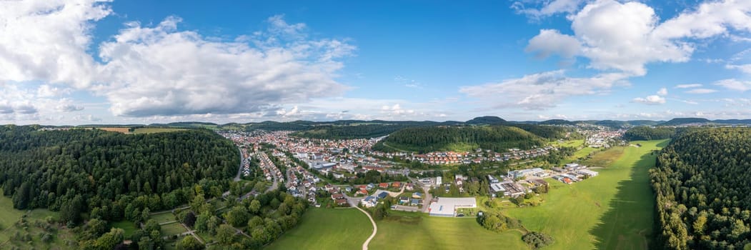 Vibrant town amidst forests, great for travel guides.