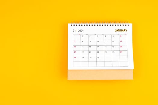 January 2024 desk calendar on yellow color background, position with copy space. Time planning day concepts.