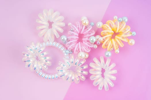 Colorful plastic hair elastics set on beautiful background.