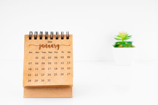 January 2024 Monthly desk calendar for 2024 year with plant pot on white background.
