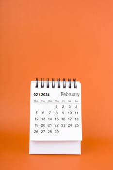 Vertical of Feburary 2024 table calendar on orange color background.