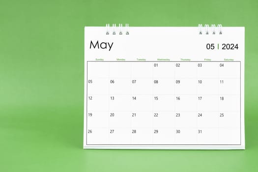 May 2024 desk calendar isolated in green color background.