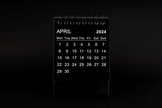 Black Calendar for April 2024. Desktop calendar on a black color background.