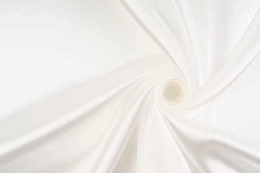 Close-up of rippled white silk fabric.