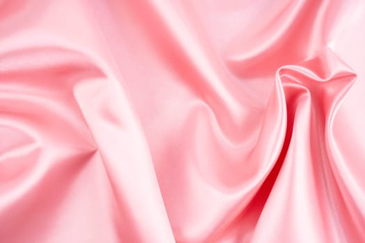 Abstract background luxury cloth wavy folds of grunge silk texture pink color.