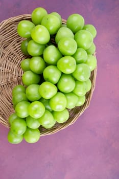 Sweet Green Shine Muscat grape in Bamboo basket on the table.