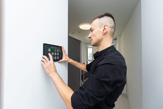 automation, internet of things and technology concept - man looking at tablet pc computer at smart home. High quality photo