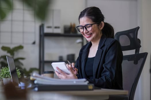 Business woman using calculator for do math finance on wooden desk in office and business working background, tax, accounting, statistics and analytic research concept.