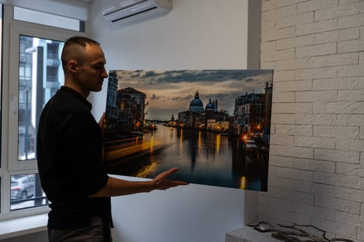 Photo canvas print. A man holding a photography with gallery wrap. High quality photo