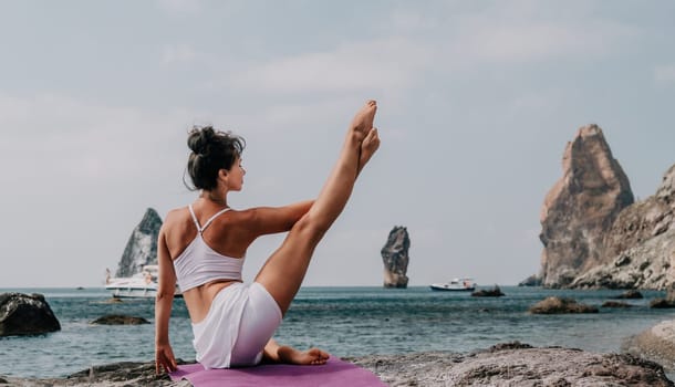 Fitness woman sea. Outdoor workout on yoga mat in park near to ocean beach. Female fitness pilates yoga routine concept. Healthy lifestyle. Happy fit woman exercising with rubber band in park.