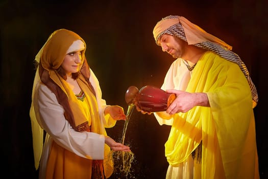 A couple in love or a married couple in stylized Eastern clothing from Israel, Palestine, Iran, Pakistan together. Tender photo session in the style of the Middle East and the Bible