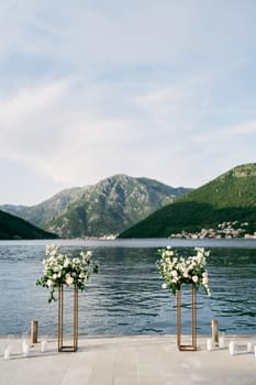 Wedding semi-arch stands on a pier by the sea. High quality photo