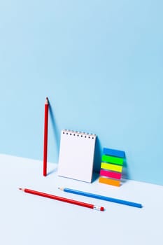 School supplies on blue background. Back to school front view picture.