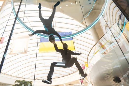 Skydivers in indoor wind tunnel, free fall simulator. High quality photo