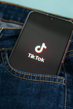 Tver, Russia-may 7, 2020, the tik tok logo on a smartphone screen sticks out of a jeans pocket. Tick-Tok icon. logo of the current app. Tiktok social network.