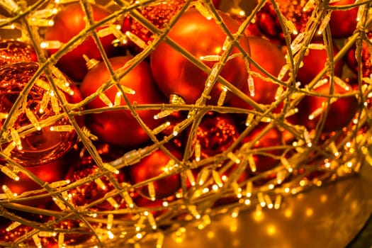 Close up of red Christmas balls baubles. Bokeh garlands. Xmas and holidays concept. Copy space and empty place for text, mock up greeting card.