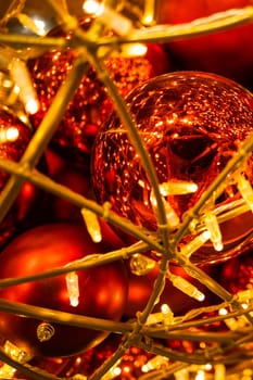 Close up of red Christmas balls baubles. Bokeh garlands. Xmas and holidays concept. Copy space and empty place for text, mock up greeting card.