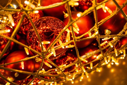 Close up of red Christmas balls baubles. Bokeh garlands. Xmas and holidays concept. Copy space and empty place for text, mock up greeting card.