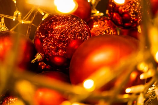 Close up of red Christmas balls baubles. Bokeh garlands. Xmas and holidays concept. Copy space and empty place for text, mock up greeting card.