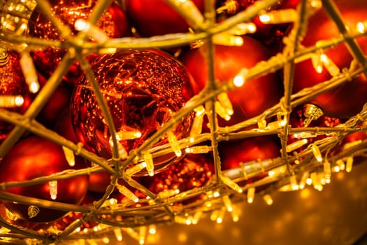 Close up of red Christmas balls baubles. Bokeh garlands. Xmas and holidays concept. Copy space and empty place for text, mock up greeting card.